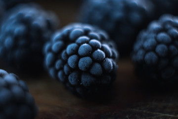 Macro of a blackberry on a wooden background.