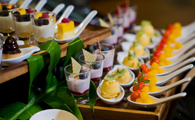 Glass shots  pastry. wedding catering food. mini canapes food.  tasty dessert. Beautiful decorate catering banquet table.  snacks and appetizers. wedding celebration