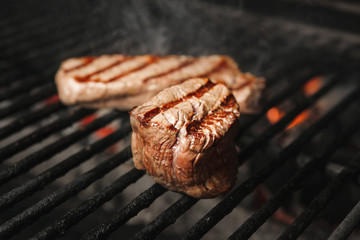 Beef steak medium roast cooking on grill, preparing meat