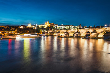 View of Charles Bridge and Vltava river at night in Prague, Czech Republic
