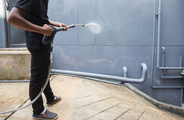 The man cleaning with high pressure water jet.