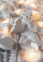 Winter holiday Christmas decorations, white wooden toys and knit