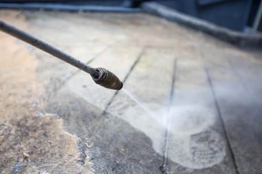 The Man Cleaning With High Pressure Water Jet.