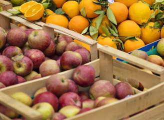 oranges and apples in the boxes on the market in Italy