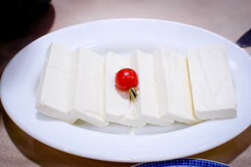 Mozzarella and cherry tomato served in an individual plate for aperitive