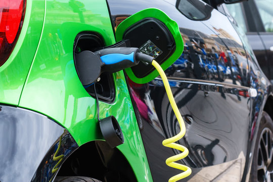 Close up of electric car being charging