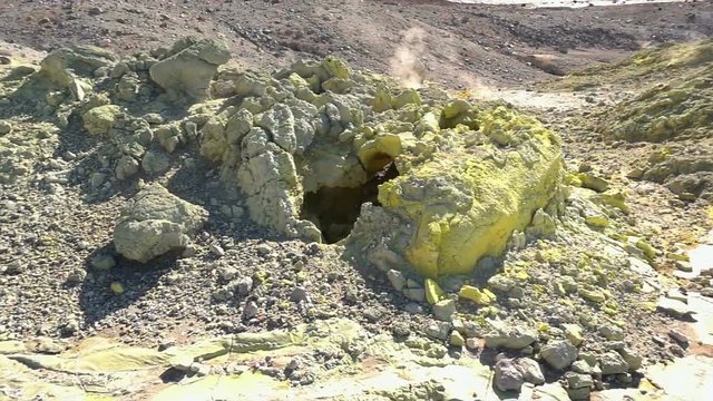 Fumarole field in Ebeko volcano caldera. Emission of hot sulfur gas.
