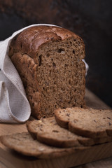 Bread is cereal with the addition of flax, sesame, oat flakes and millet on a wooden table, closeup