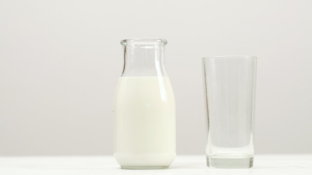 Glass bottle full of milk on white background. Organic dairy. Natural drink healthy lifestyle. Copy space concept