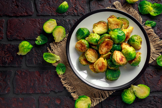 Homemade Roasted Brussel Sprouts with Salt, Pepper on a old stone rustic table.