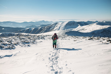 Fototapeta na wymiar climber walking downhill in winter