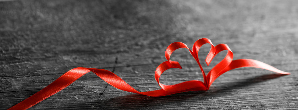 Two ribbon hearts on wood