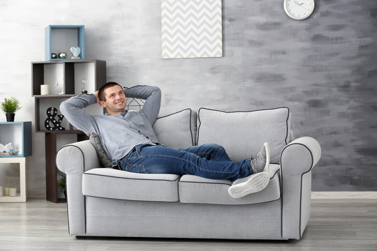 Young man relaxing on sofa at home