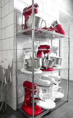Shelving with kitchen utensils and cutlery in bakery
