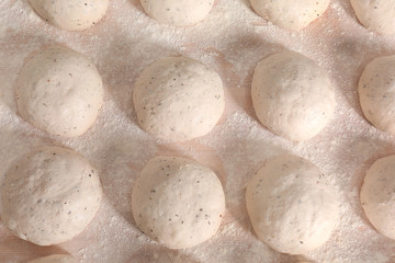 Raw loaves of bread on table