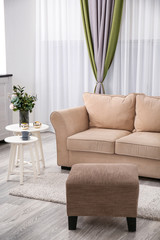 Stylish sofa in interior of living room