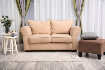 Stylish sofa in interior of living room