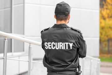 Obraz premium Male security guard near building outdoors