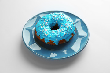 Plate with blue donut on white background