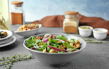 Bowl with delicious vegetable salad on table
