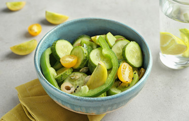 Bowl with delicious vegetable salad on table
