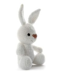 Cute knitted toy bunny on white background