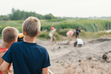 Fototapeta premium little boy archaeologist makes the measurement depends on the optical level