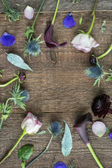 interior decoration, presents, lifestyle concept. beautiful flowers from garden that are arranged, they compose a frame of round form on the wooden background of desk