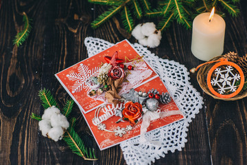 a Christmas cards, candles, fir branches on dark background