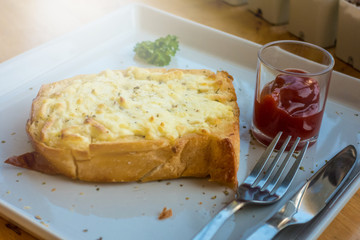 Cheese toast with ketchup serving on table
