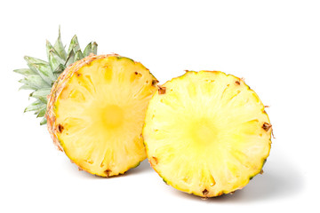 Two halves of a ripe pineapple on a white