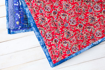 home atmosphere, tradition, decoration, needlework concept - bright plaid has lots of beautiful multicolored flowers in interesting doodle style with curlicues, dots and fancy leaves on the inner side