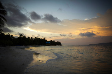 sunset by the beach in raja ampat archipelago