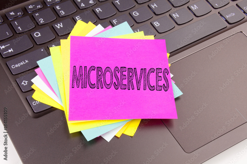 Aufkleber writing microservices text made in the office close-up on laptop computer keyboard. business concept
