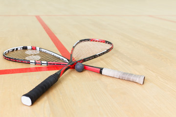 two squash rackets and ball