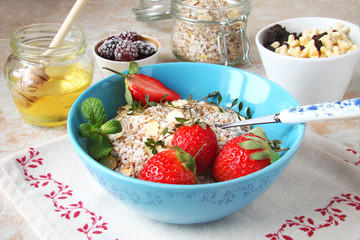 Cereal with grapes and strawberries, dried fruit, honey