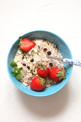 Cereal with grapes and strawberries, dried fruit, honey