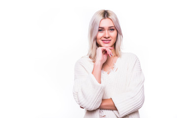 Happy young woman with a smile on her face dressed in white touching her chin on white. People, youth, leisure and lifestyle concept.