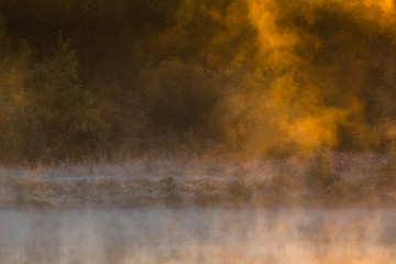 Image of morning mist over the surface of water 