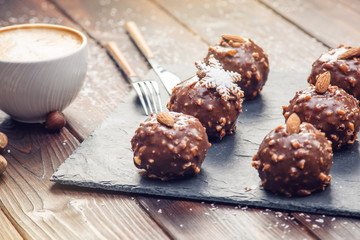 Homemade Christmas or New Year holiday chocolate brownies with nuts on wooden background. Concept of festive desserts