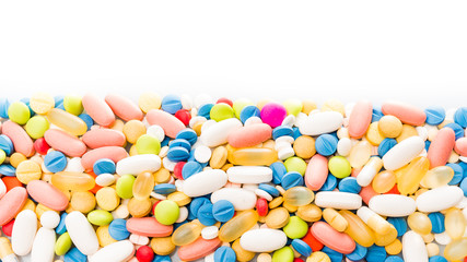 pills border over white. colorful pills isolated on white