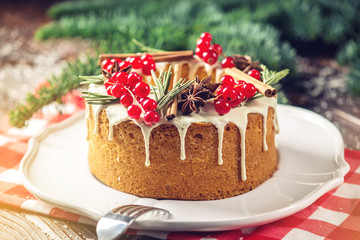 Homemade Christmas or New Year holiday berry cake decorated currants and rosemary. Concept of festive desserts