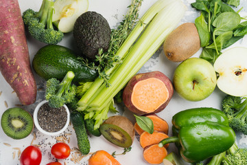 Green fruits and vegetables on white background