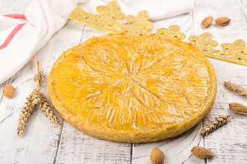 Homemade Galette des Rois cake with handmade kings crown. Traditional French Epiphany cake with ground almond