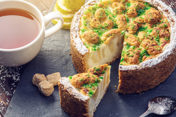 Homemade Christmas or New Year holiday pear pie decorated in a rustic style. Concept of festive desserts