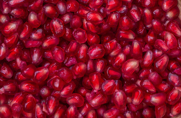 Dissected fruit fresh red pomegranate texture, background top view macro. 