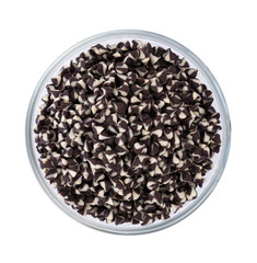 Chocolate chip morsels spread in bowl on white