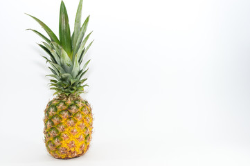 Fresh, healthy single pineapple close up shot isolated on white background.