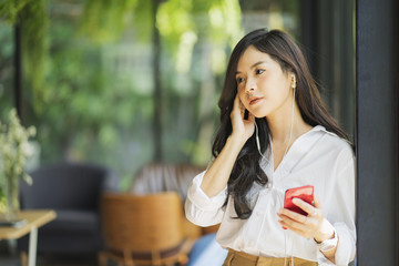 Young business woman listening music with headphones