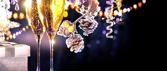 Christmas scene. Flutes with sparkling champagne over holiday background